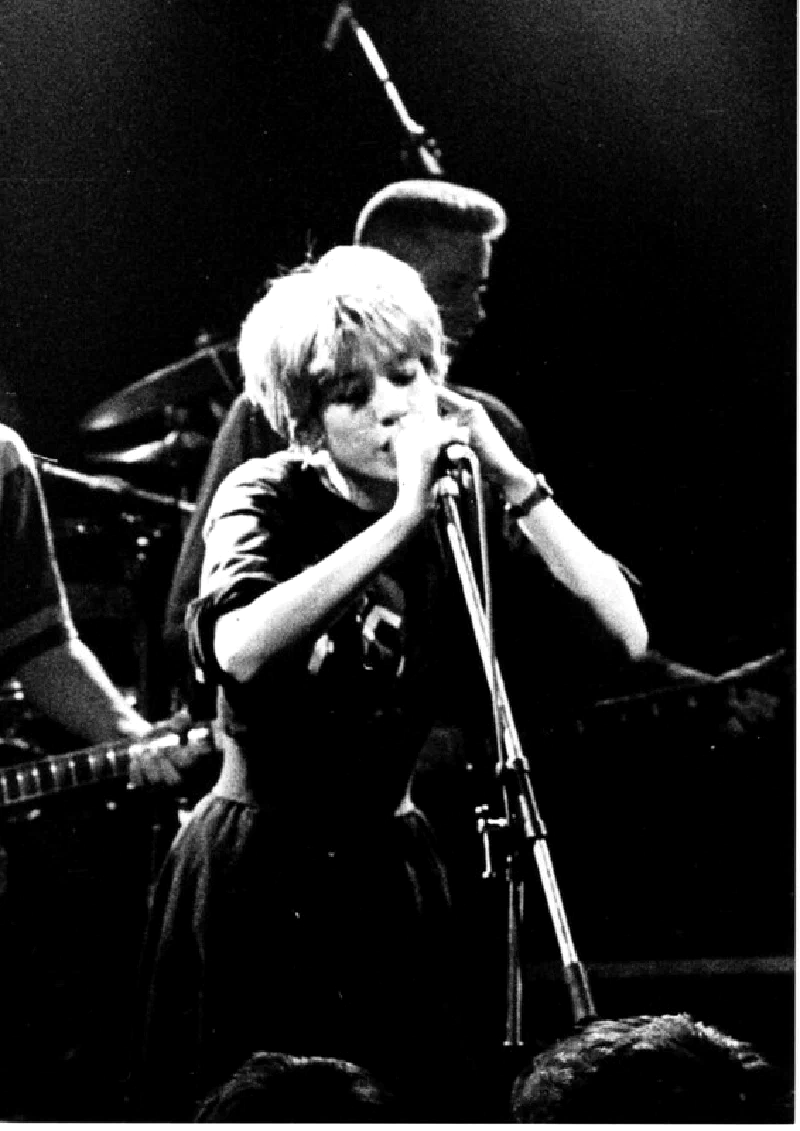 Miki Berenyi, singer of Lush, at the mic on stage, grainy black-and-white photograph taken from the pit, circa 1990