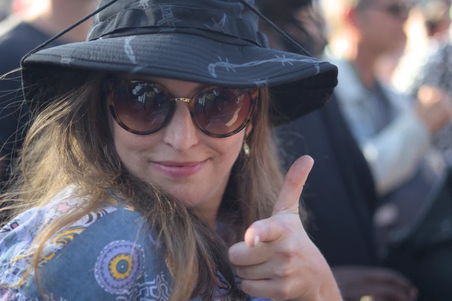 Festival-goer in a barbed-wire bucket hat and tortoiseshell sunglasses pointing at the camera, Binic Folk Blues Festival 2025